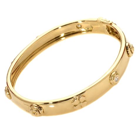 chanel camellia gold bangle.